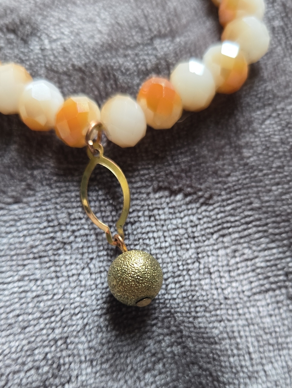 Stretchy Faceted Orange & Cream Beaded Stretch Bracelet with Gold Charm Dangle - Picture 3 of 4